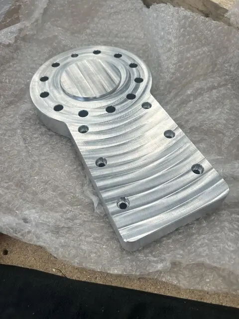 Second machined view of the aluminium spindle plate showing the boss and fixing holes.